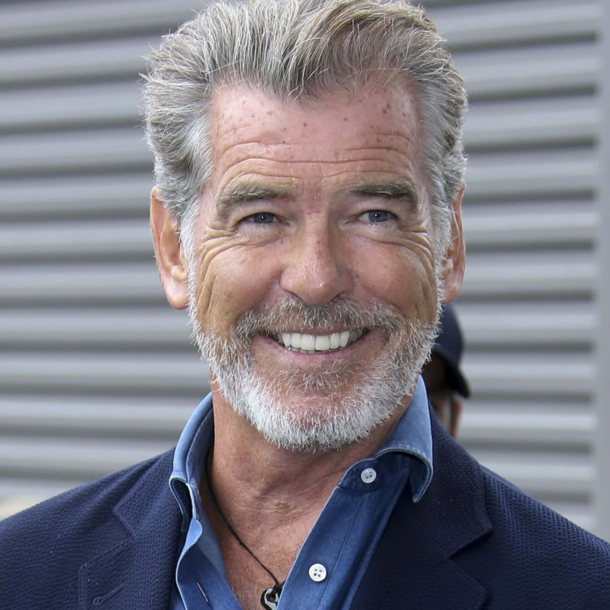 A smiling man from The Print 4 Team, with gray hair and a beard, wearing a blue shirt and dark blazer.
