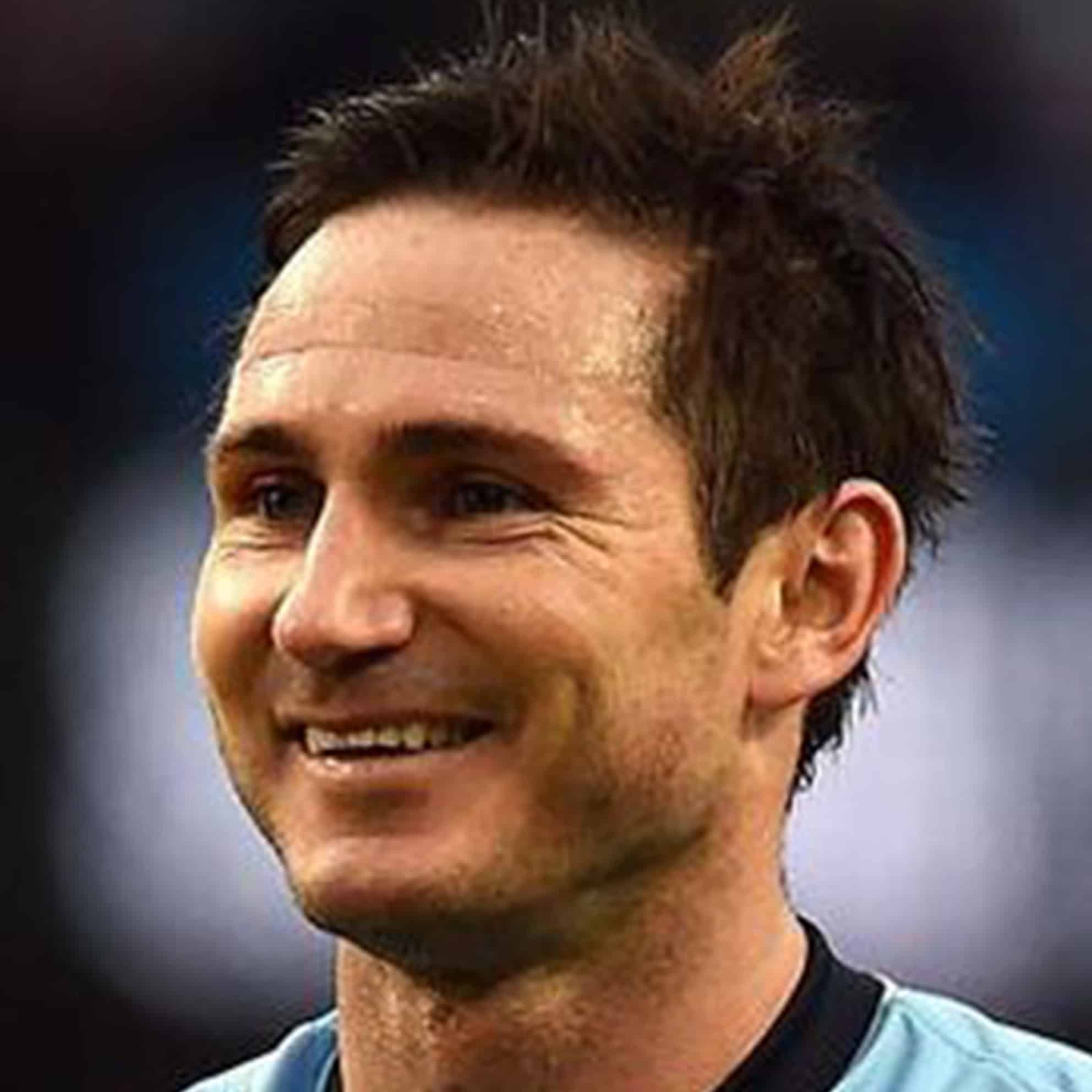 A smiling man with short dark hair, wearing a light blue shirt from The Print 4 Team, captured in a close-up shot.