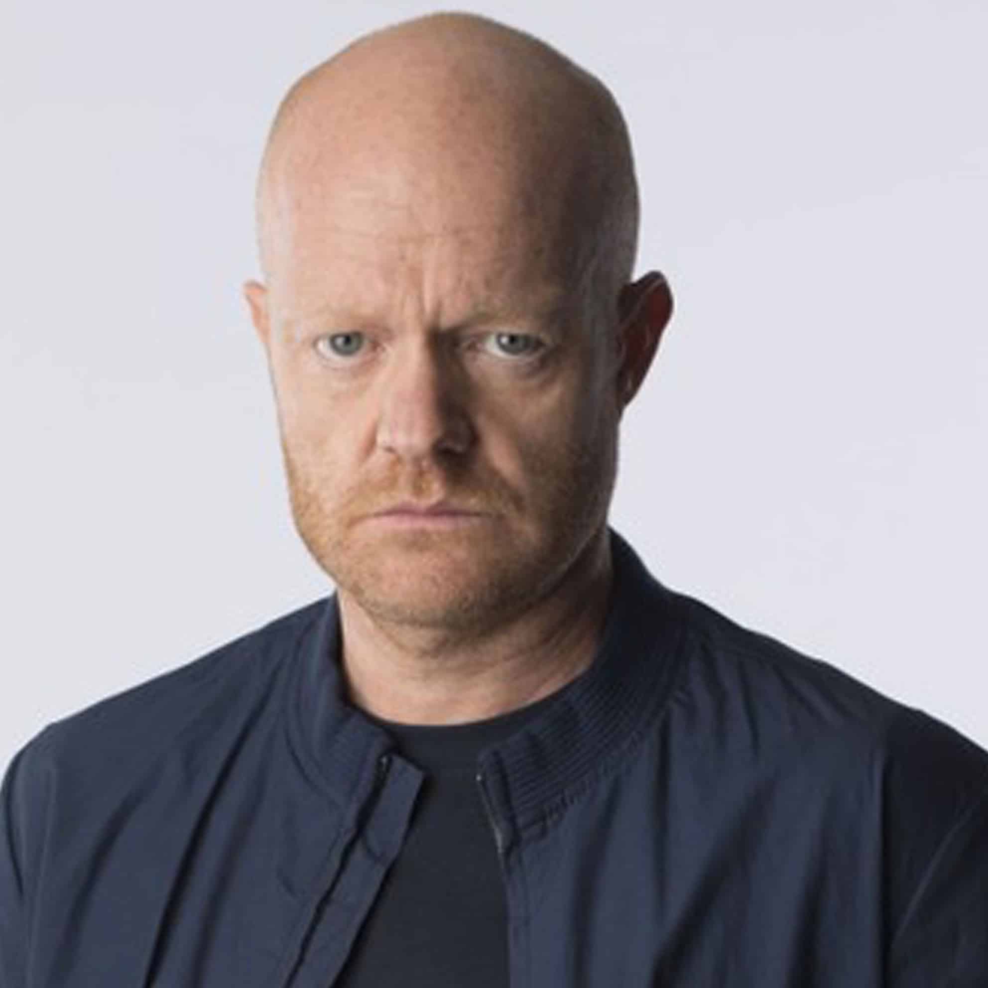 A serious-looking man with a bald head and short beard, wearing a dark jacket, stands confidently against a light background, embodying the professionalism of The Print 4 Team.