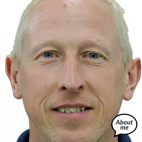Close-up of a smiling man with short light hair and a speech bubble saying "About me." He's part of The Print 4 Team.