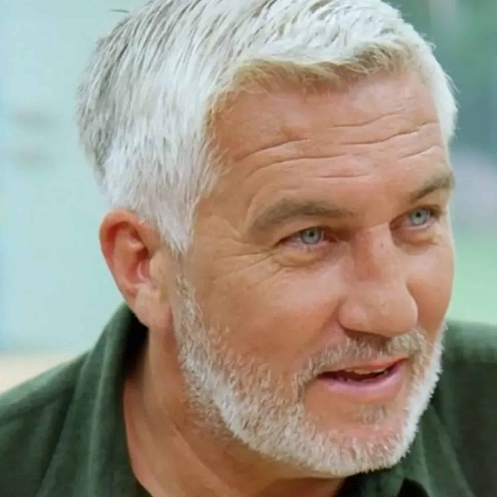 A man with short white hair and a beard, wearing a green shirt, looks slightly to the side with a smile—like he's just heard good news from The Print 4 Team.